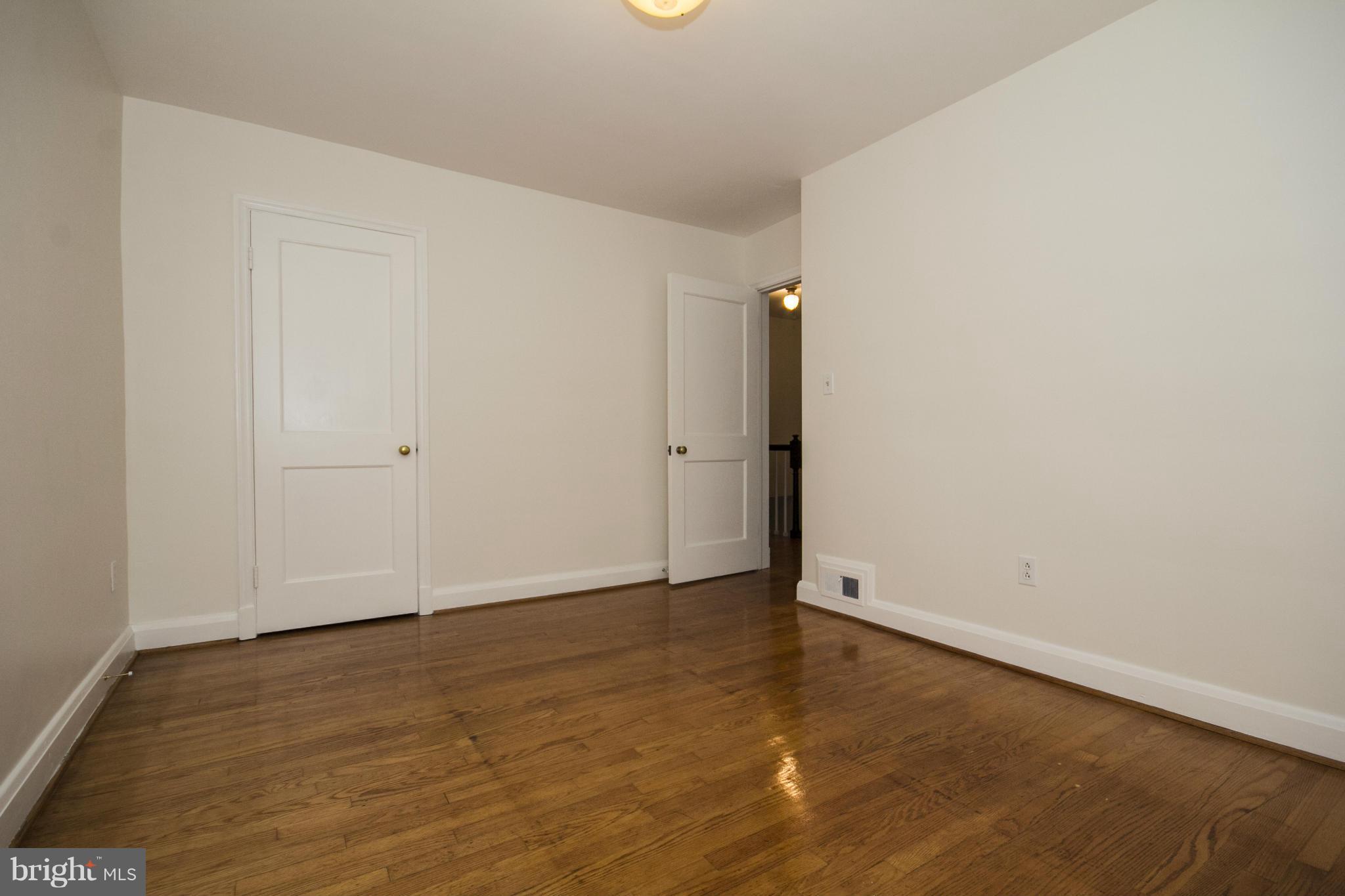 5626 Sagra Road Baltimore, MD 21239 - Photo 13 of 27 an empty room with wooden floor
