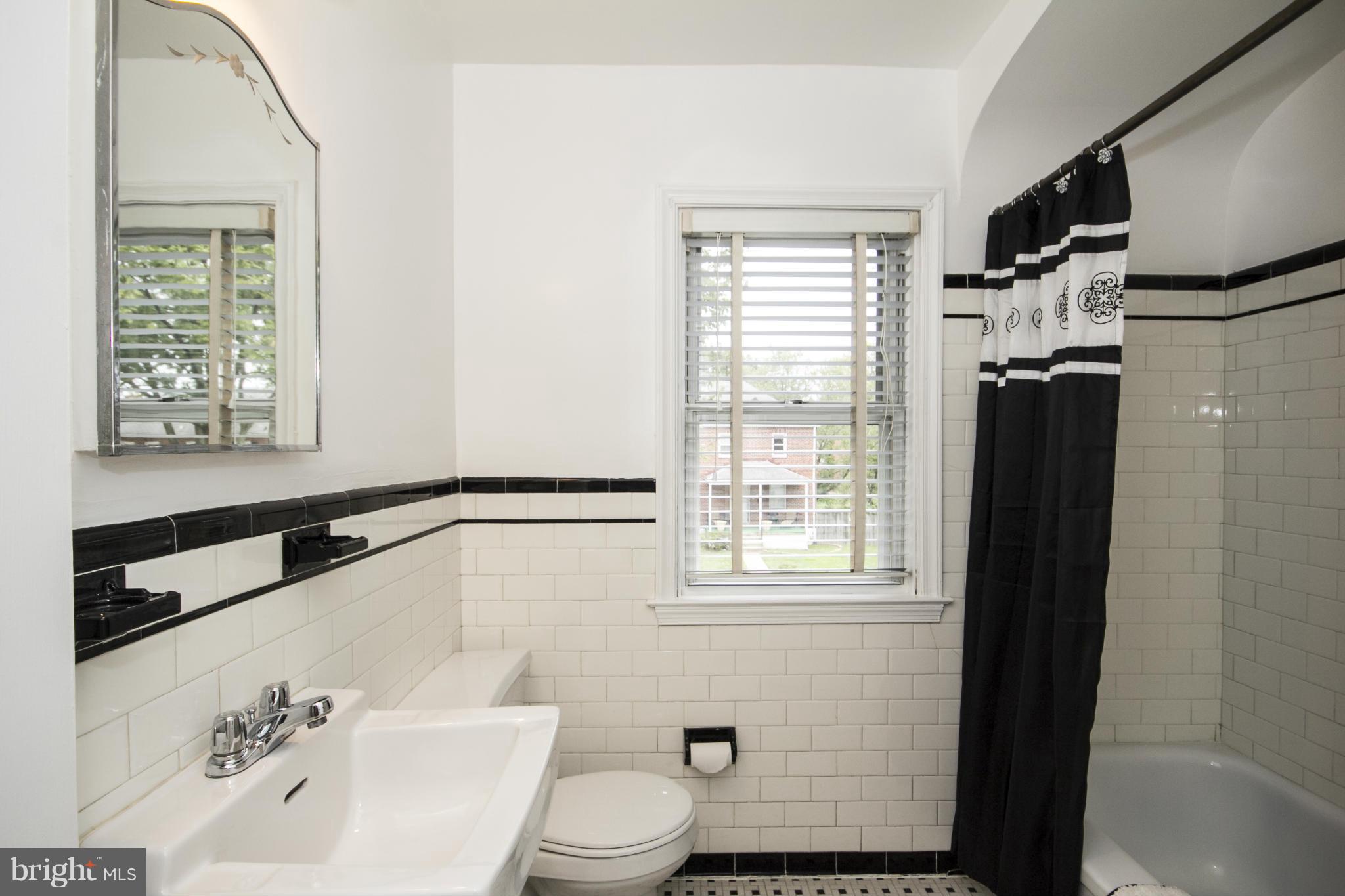 5626 Sagra Road Baltimore, MD 21239 - Photo 15 of 27 a bathroom with a bathtub and a shower
