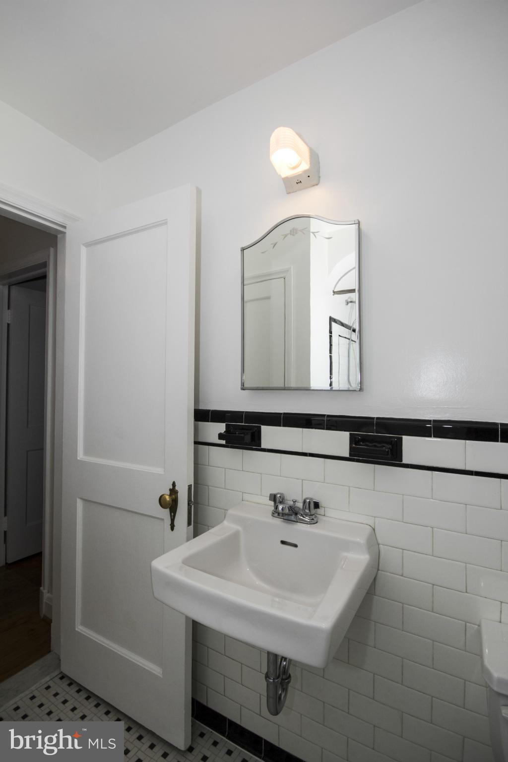 5626 Sagra Road Baltimore, MD 21239 - Photo 16 of 27 a bathroom with a sink a toilet and mirror