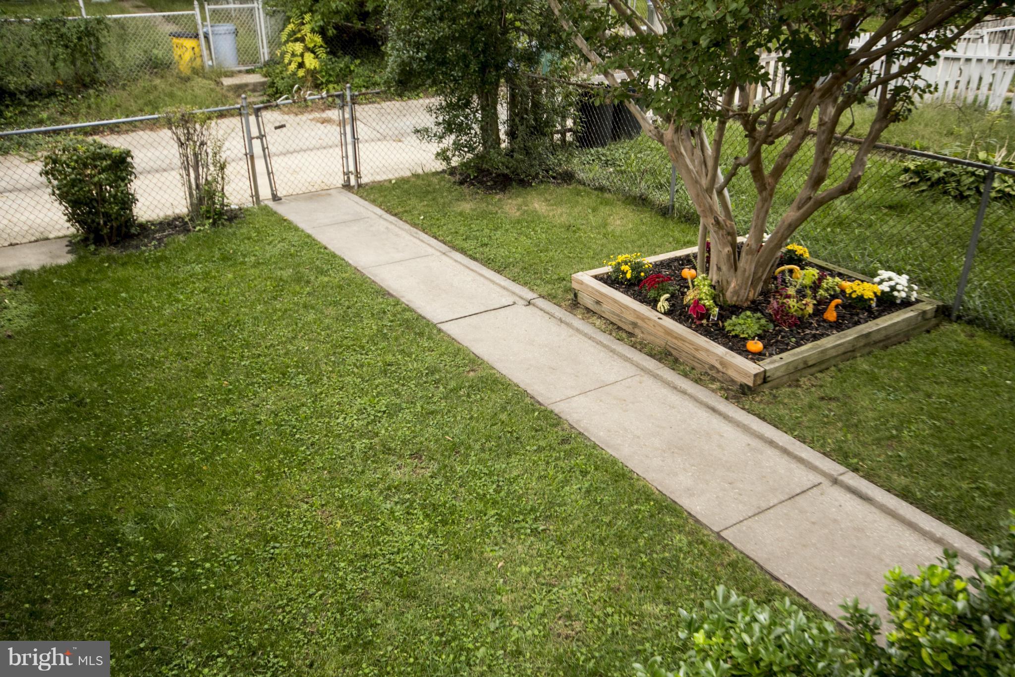 5626 Sagra Road Baltimore, MD 21239 - Photo 19 of 27 a view of a backyard with a garden