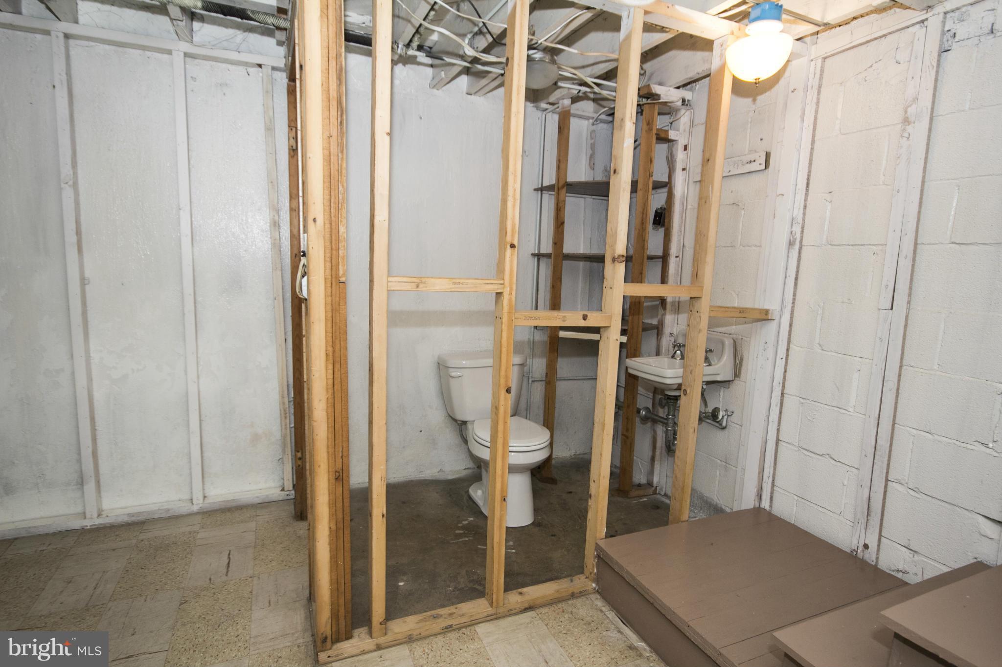 5626 Sagra Road Baltimore, MD 21239 - Photo 22 of 27 a bathroom with a shower and toilet
