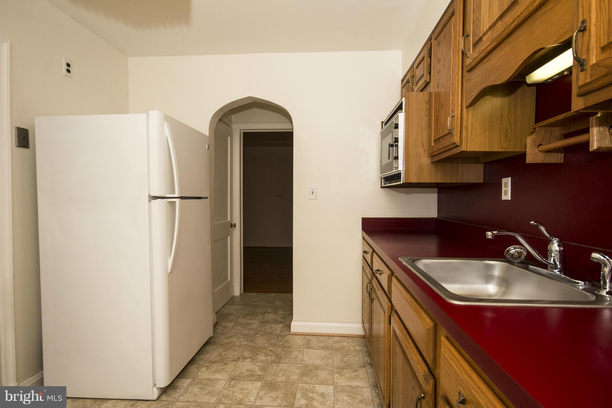 5626 Sagra Road Baltimore, MD 21239 - Photo 9 of 27 a kitchen with stainless steel appliances granite countertop a refrigerator and a sink