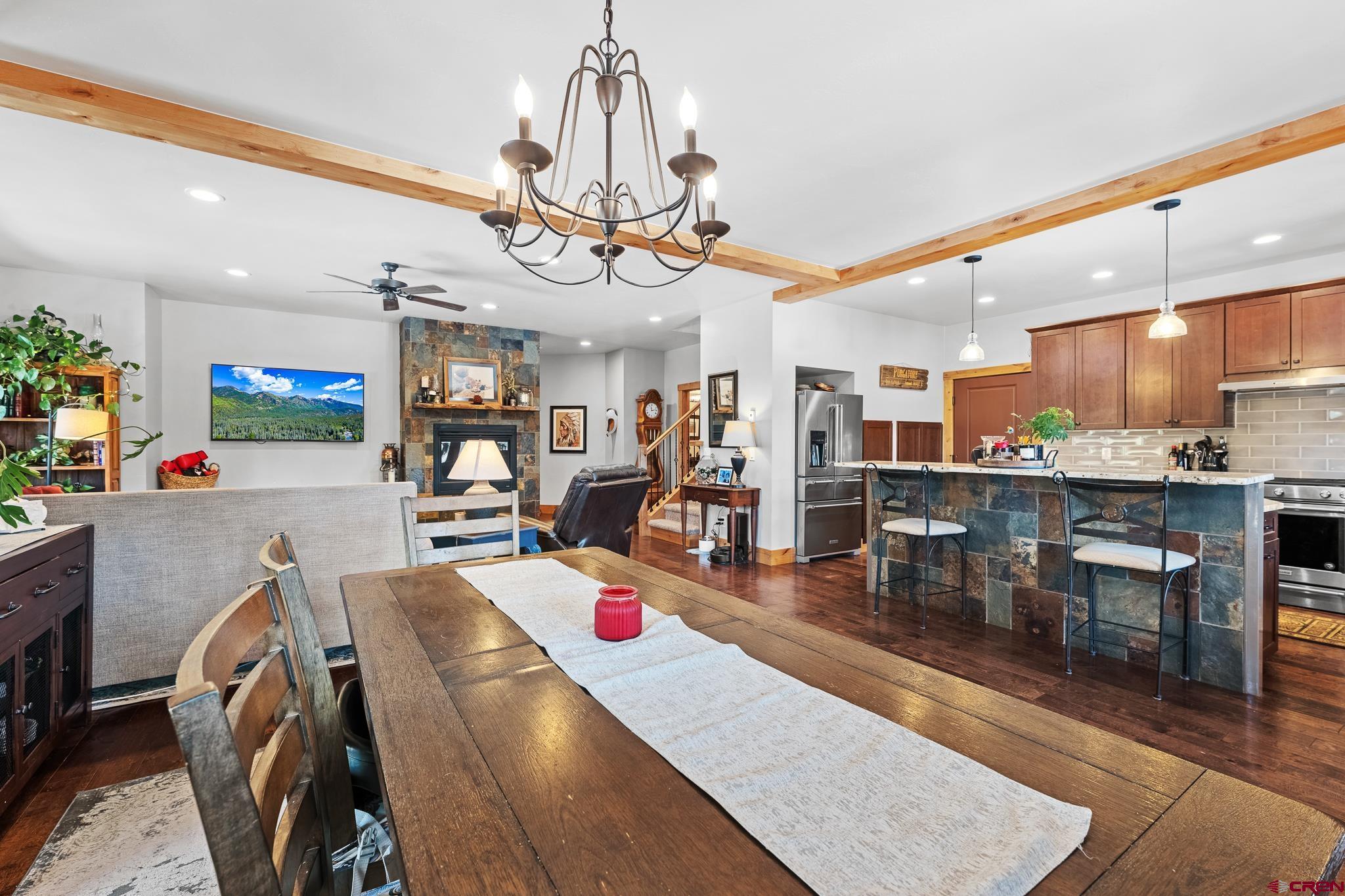 51 West Fork Road Durango, CO 81303 - Photo 11 of 35 a view of a dining room and livingroom with furniture wooden floor a chandelier