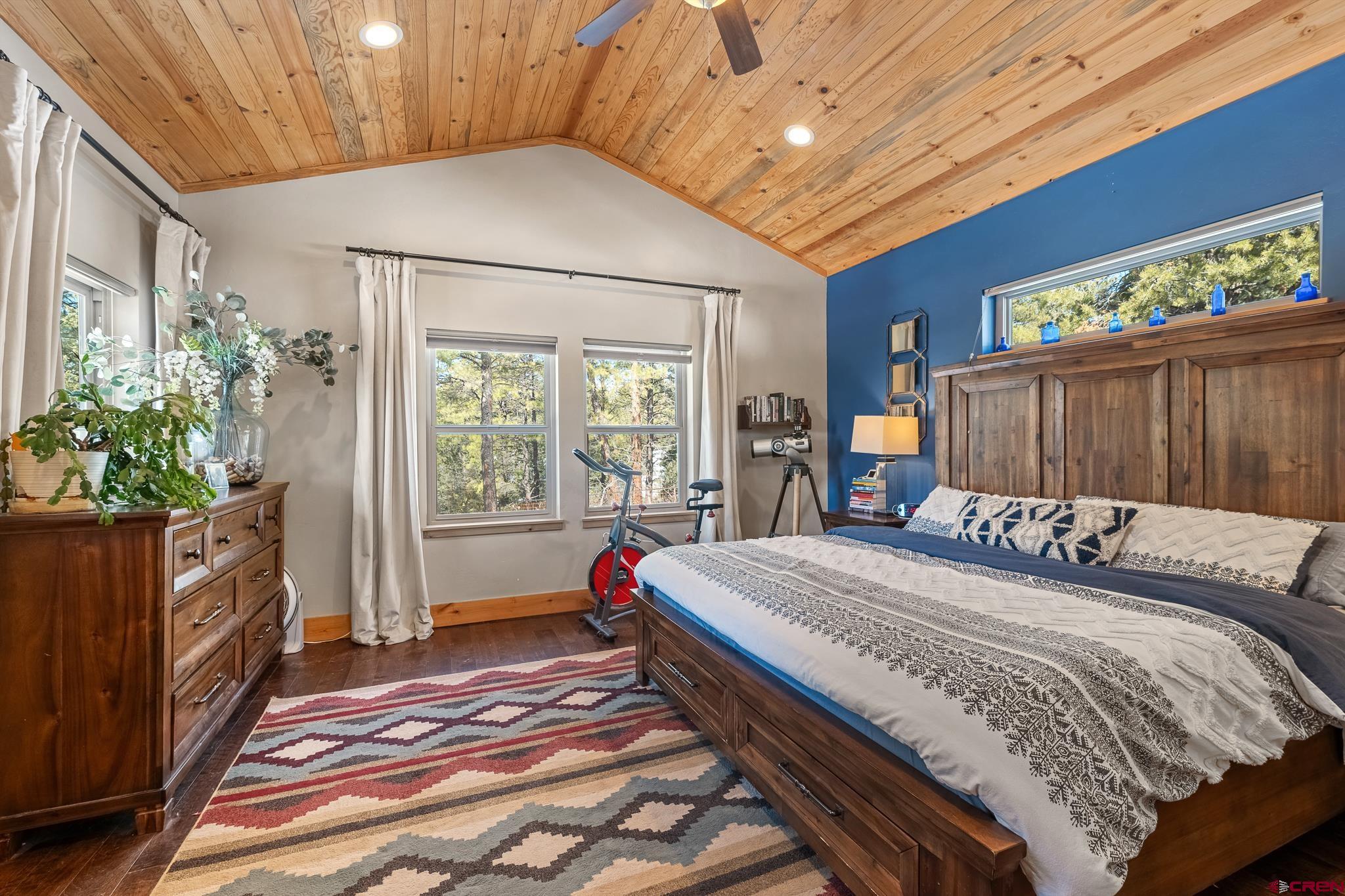 51 West Fork Road Durango, CO 81303 - Photo 14 of 35 a bedroom with a large bed and a chandelier