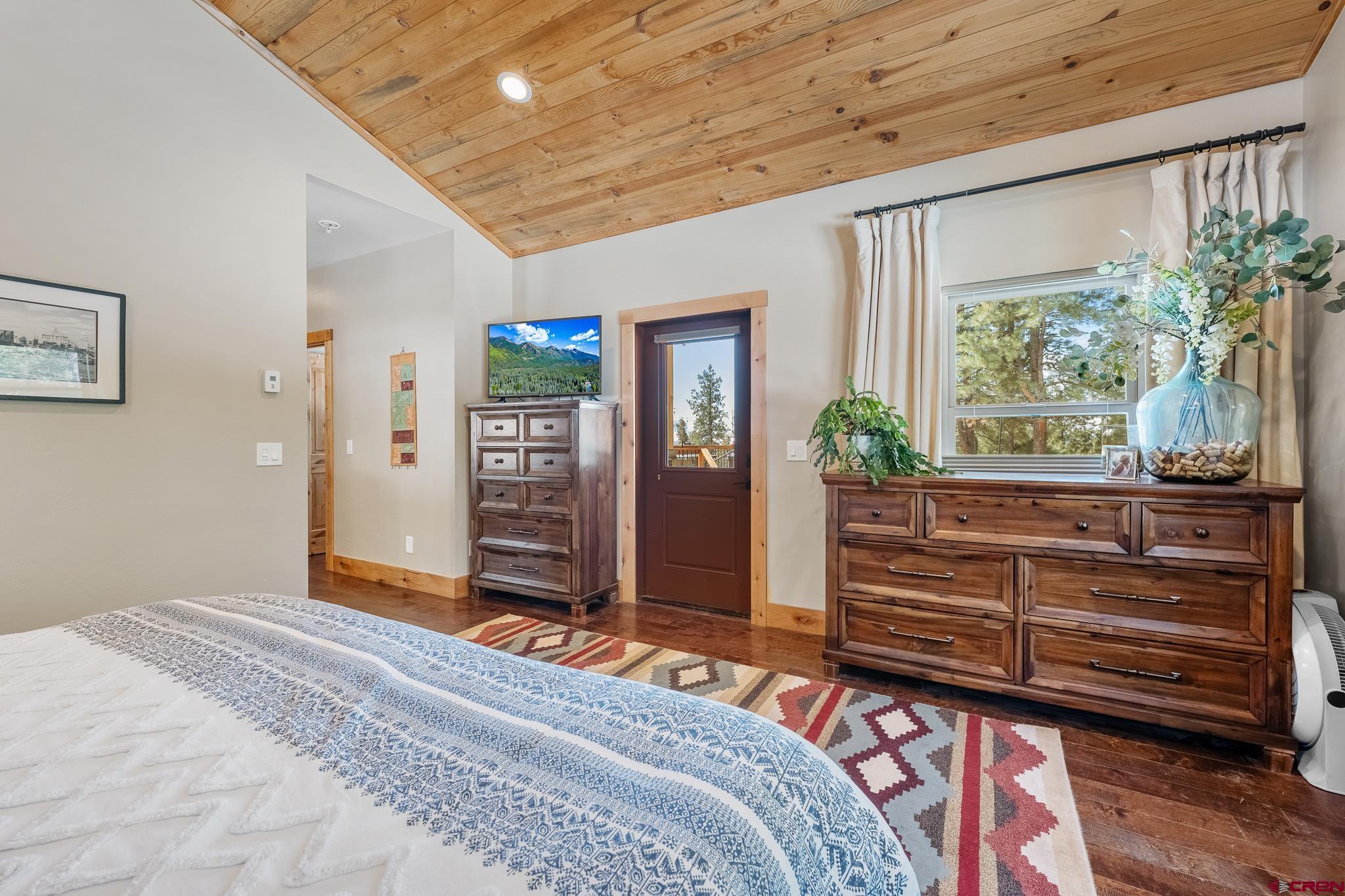 51 West Fork Road Durango, CO 81303 - Photo 15 of 35 a bedroom with a bed and a dresser next to a window