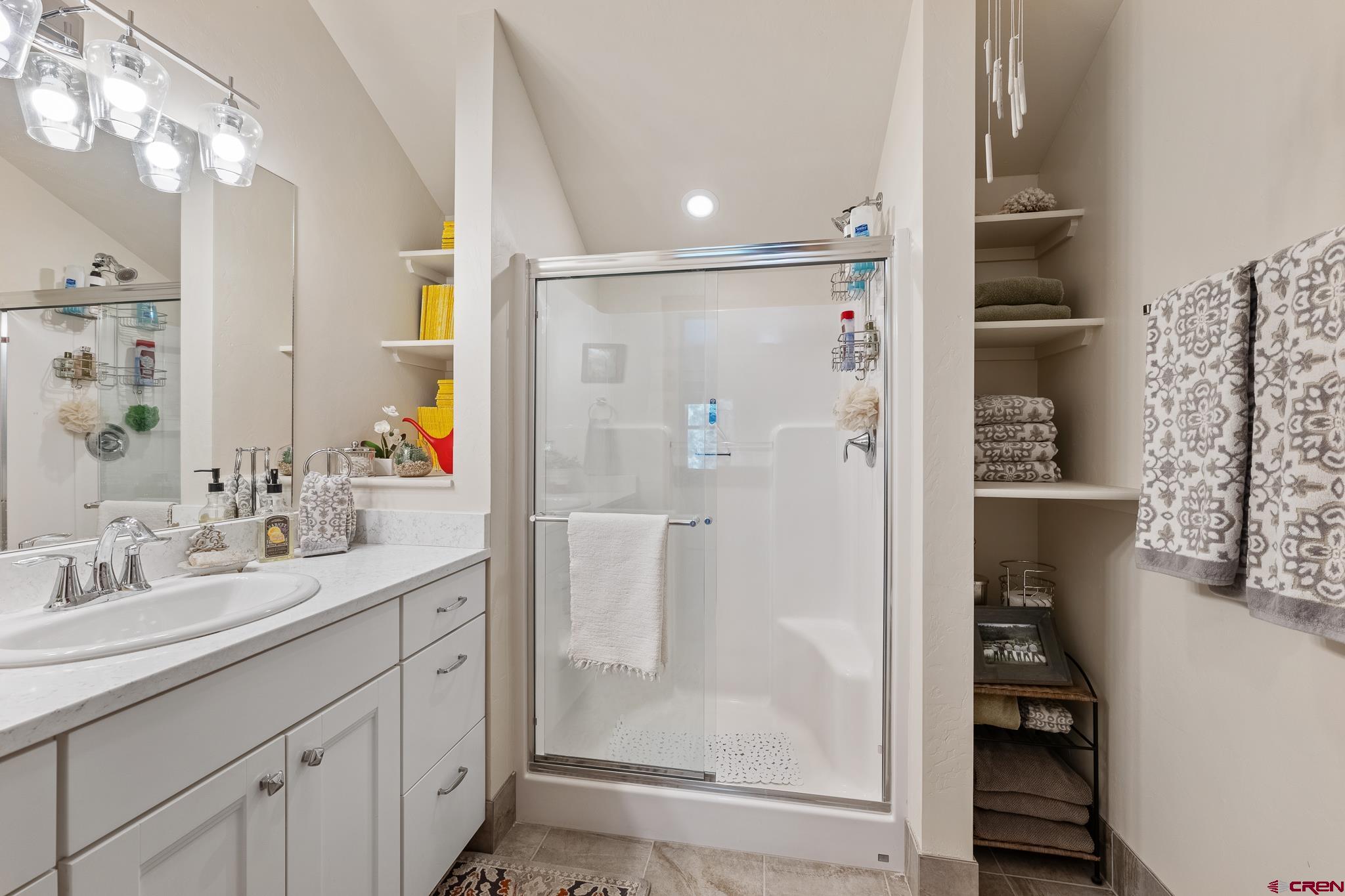 51 West Fork Road Durango, CO 81303 - Photo 27 of 35 a bathroom with a shower sink and mirror