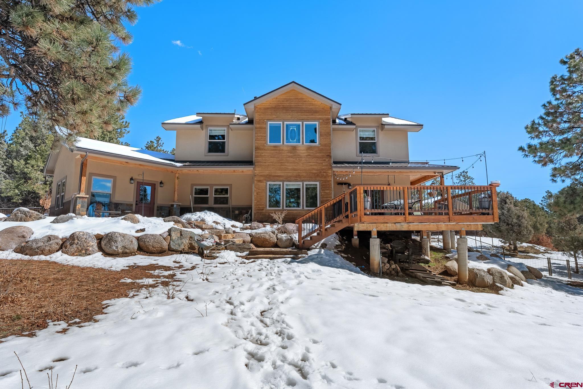 51 West Fork Road Durango, CO 81303 - Photo 32 of 35 a front view of a house with a yard covered in snow