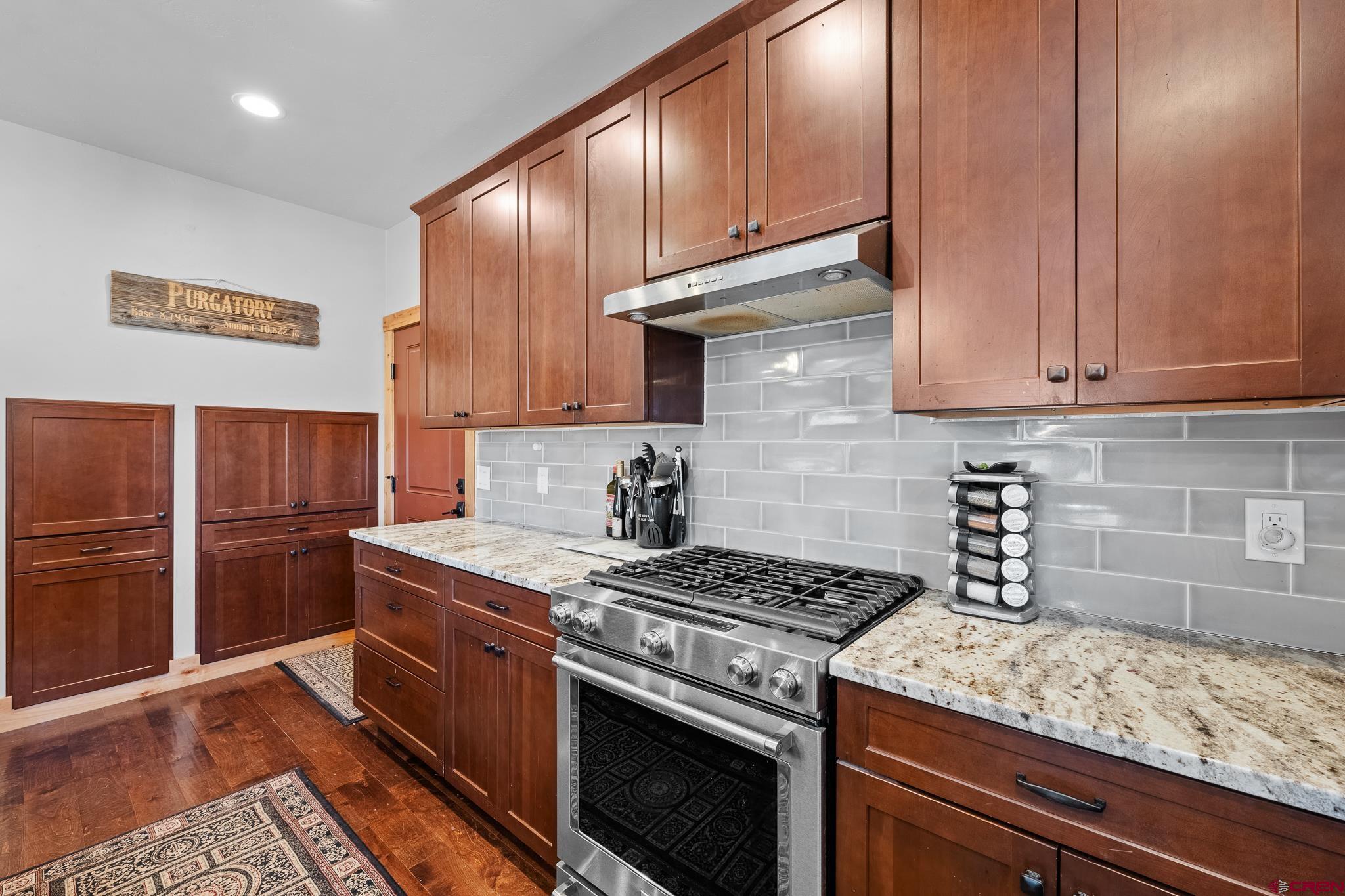 51 West Fork Road Durango, CO 81303 - Photo 8 of 35 a kitchen with granite countertop a stove sink and cabinets