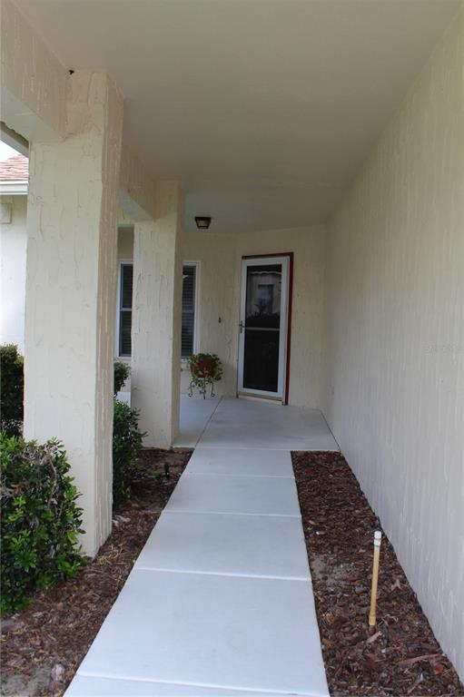 11541 Orleans Lane Port Richey, FL 34668 - Photo 3 of 24 a hallway with a white walls and a rug