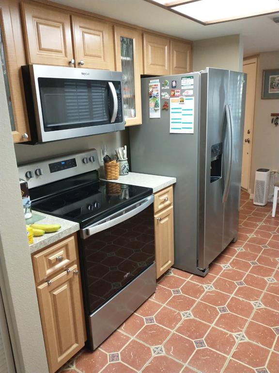 11541 Orleans Lane Port Richey, FL 34668 - Photo 8 of 24 a kitchen with granite countertop a stove and a microwave