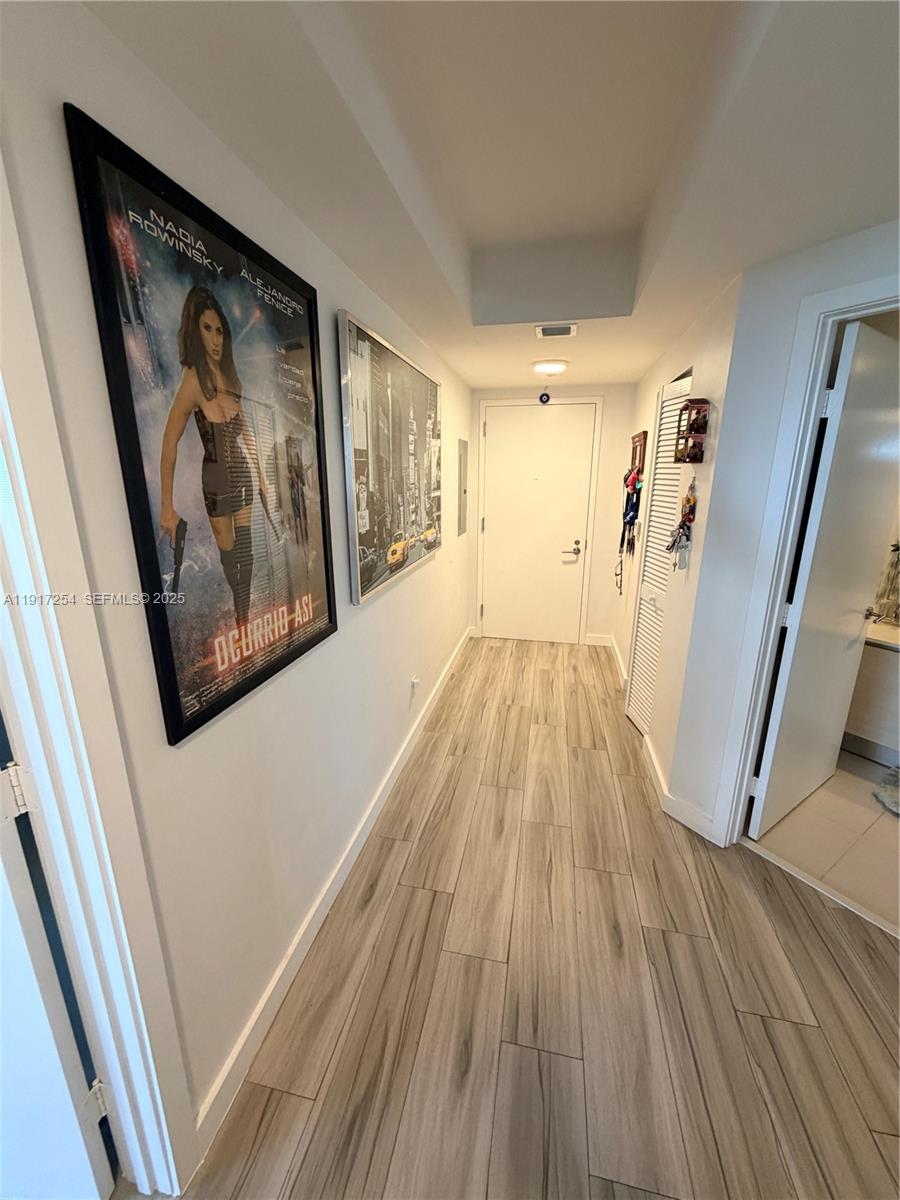 4250 Biscayne Boulevard, Unit 902 Miami, FL 33137 - Photo 15 of 30 a view of a hallway with wooden floor and stairs