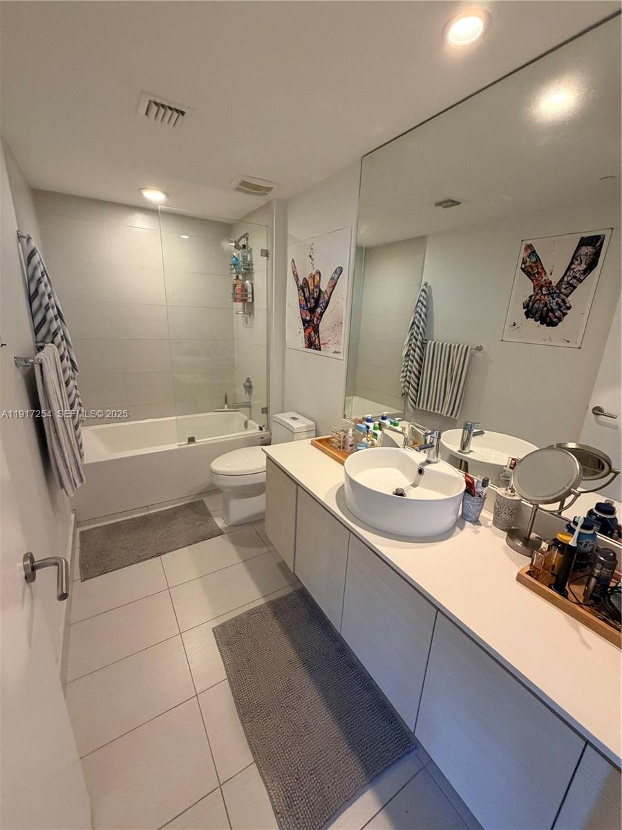 4250 Biscayne Boulevard, Unit 902 Miami, FL 33137 - Photo 19 of 30 a bathroom with a double vanity sink a toilet and shower