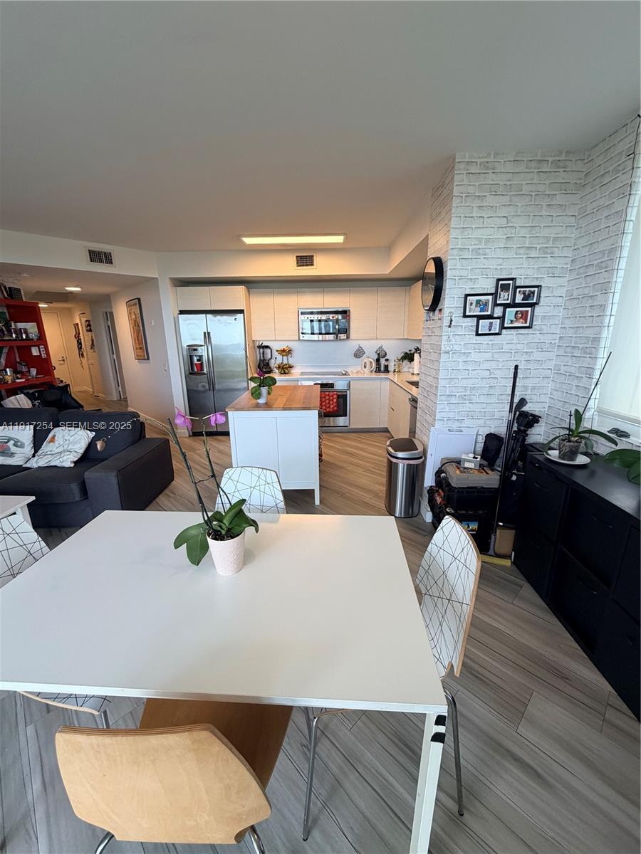 4250 Biscayne Boulevard, Unit 902 Miami, FL 33137 - Photo 20 of 30 a living room with furniture and a wooden floor