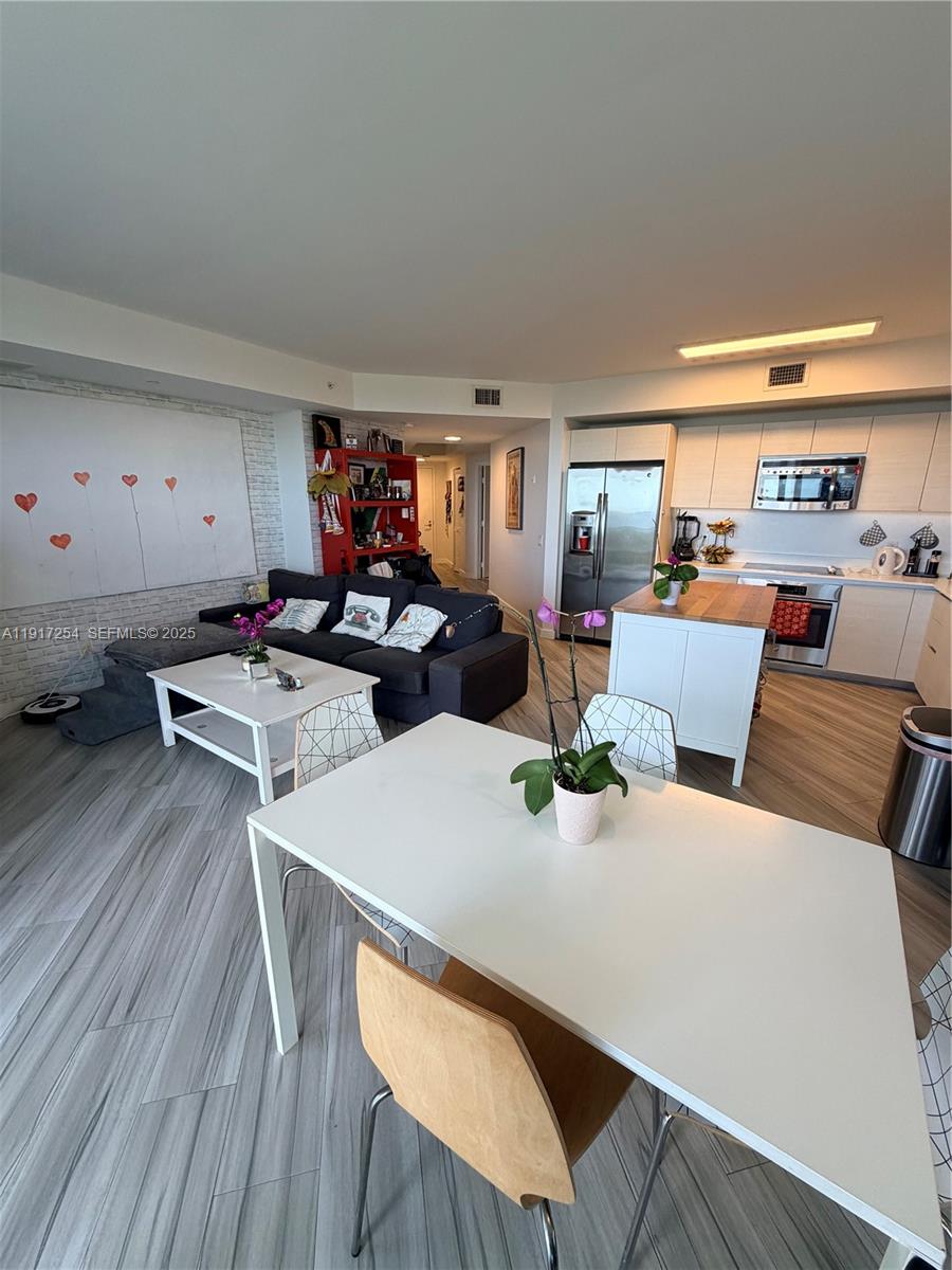 4250 Biscayne Boulevard, Unit 902 Miami, FL 33137 - Photo 21 of 30 a living room with furniture and a wooden floor