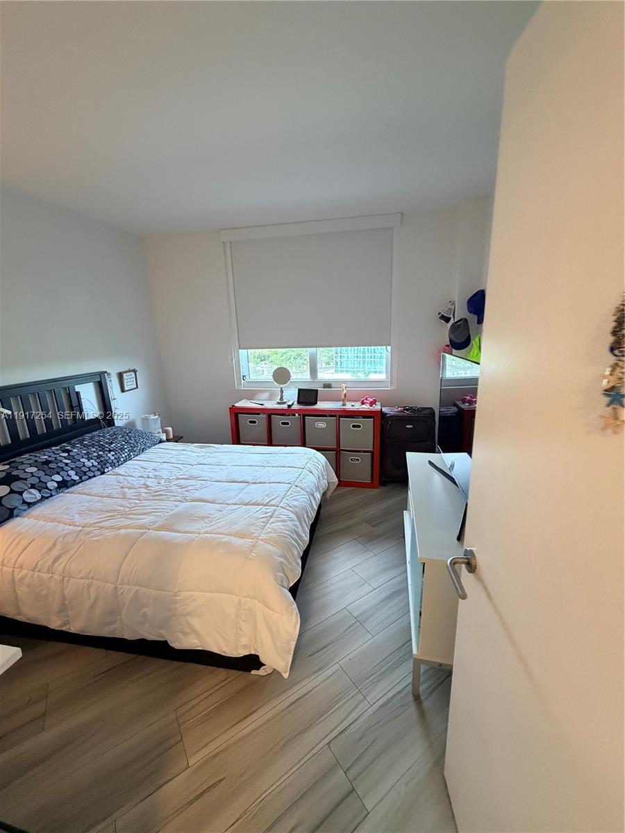 4250 Biscayne Boulevard, Unit 902 Miami, FL 33137 - Photo 8 of 30 a bedroom with a bed and a desk