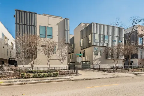 a street corner with a building in the background