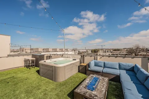 a terrace with outdoor seating and barbeque oven