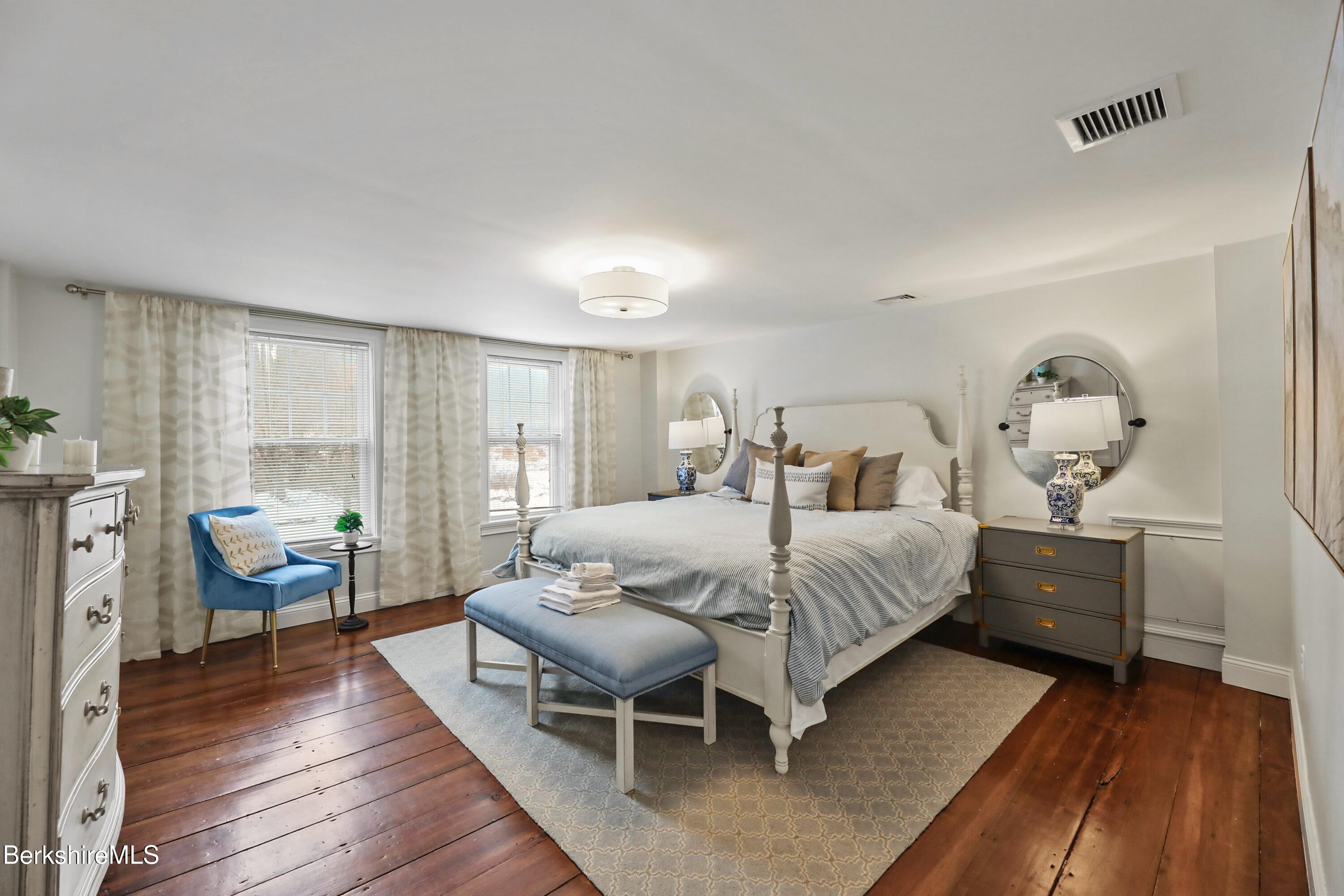 1 Devon Road Stockbridge, MA 01262 - Photo 21 of 58 a bedroom with a bed and wooden floor