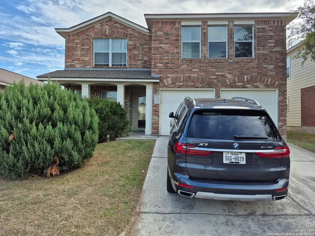 a car parked in front of a brick house