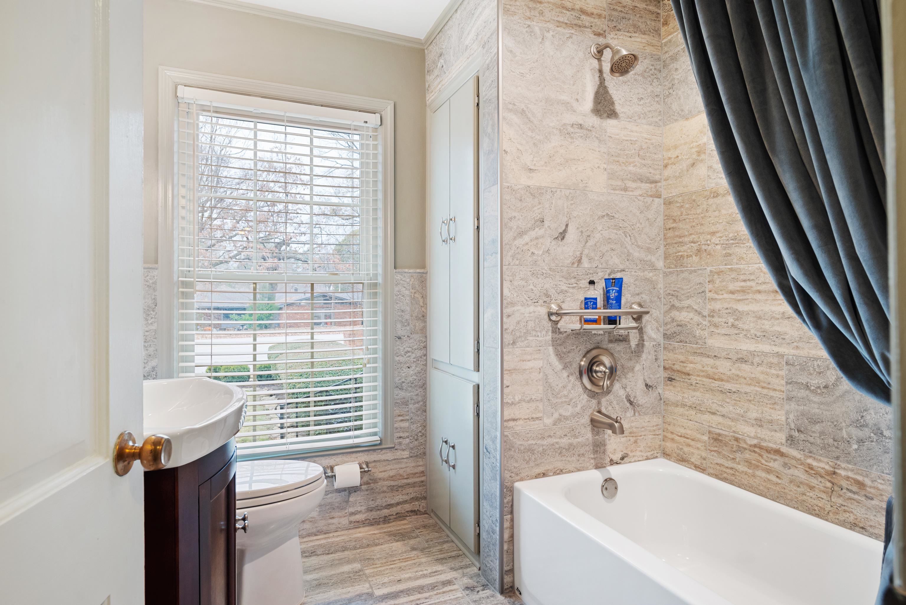 52 North Yates Road Memphis, TN 38120 - Photo 29 of 40 a bathroom with a bathtub and shower