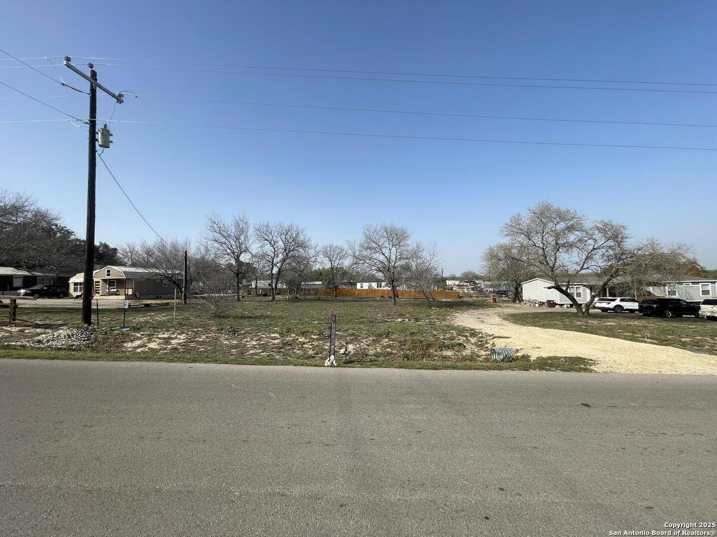 116 Rocky Ridge Drive Poteet, TX 78065 - Photo 12 of 13 a view of a building with a road