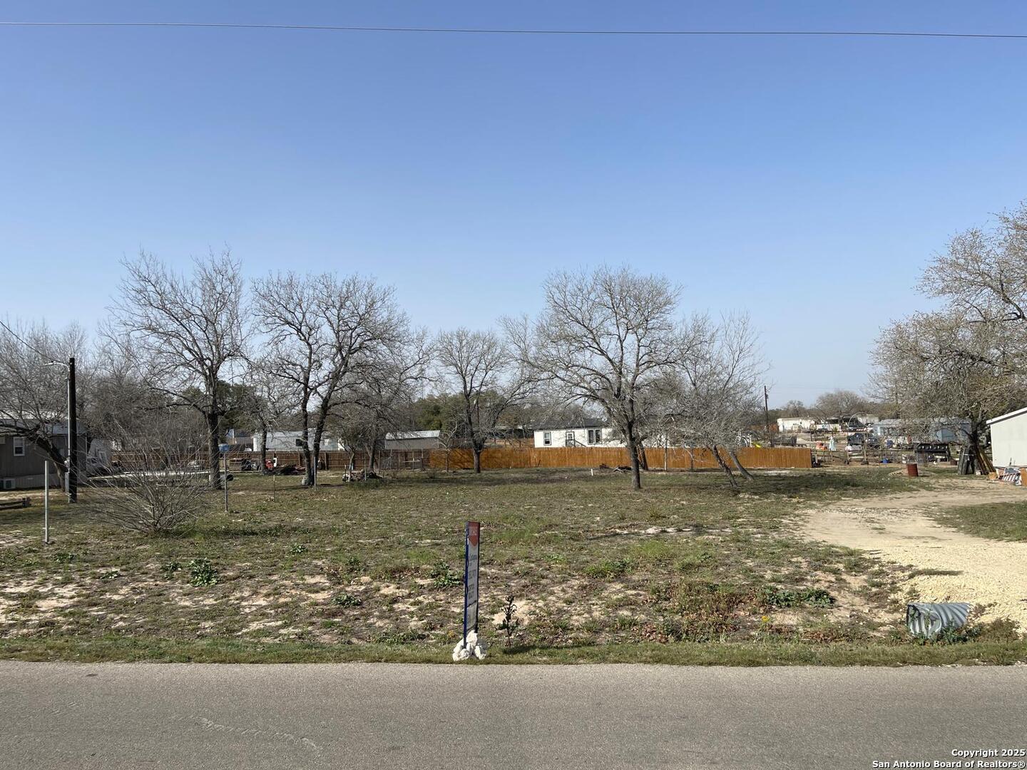 116 Rocky Ridge Drive Poteet, TX 78065 - Photo 8 of 13 a backyard of a house with lots of green space