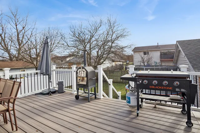 a view of a roof deck with wooden floor and fence