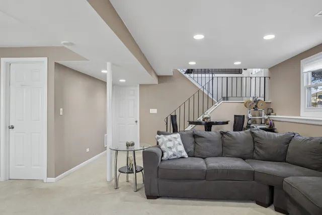 a living room with furniture and a chandelier