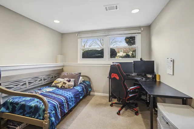 a bedroom with a bed and a desk