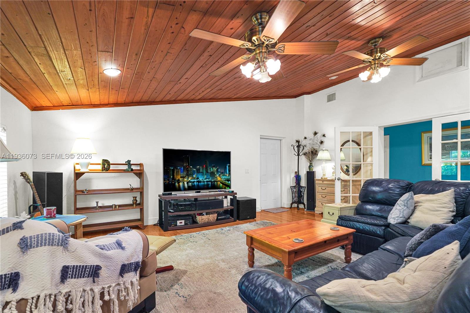 6551 Southwest 126th Street Pinecrest, FL 33156 - Photo 11 of 30 a living room with furniture and a flat screen tv