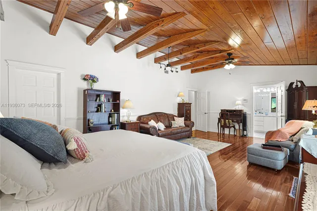 a bedroom with furniture and a chandelier