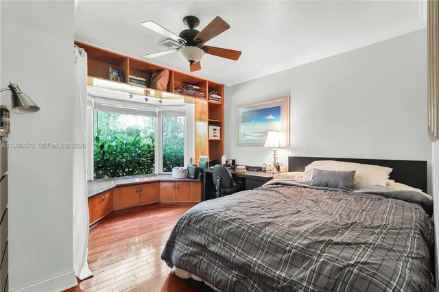 a bedroom with a large bed and a large window