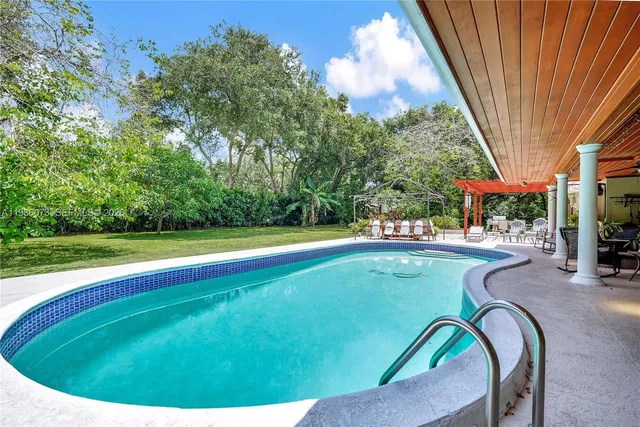 a view of a swimming pool with a patio