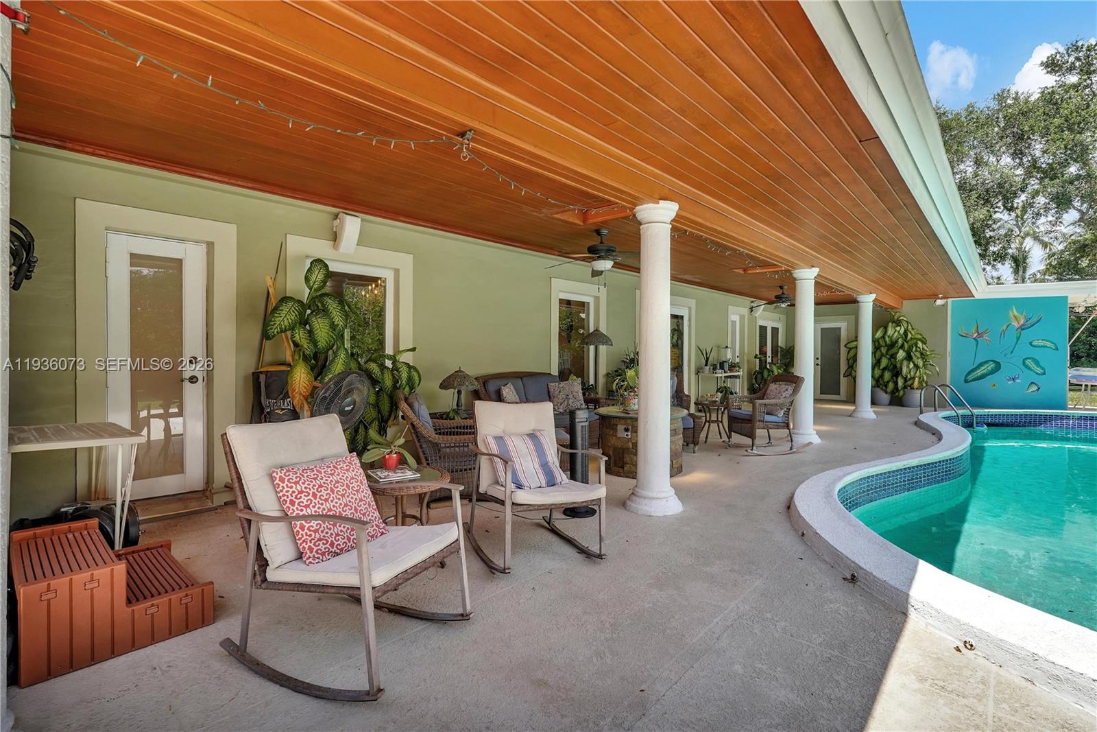 6551 Southwest 126th Street Pinecrest, FL 33156 - Photo 29 of 30 a view of a patio with table and chairs and potted plants