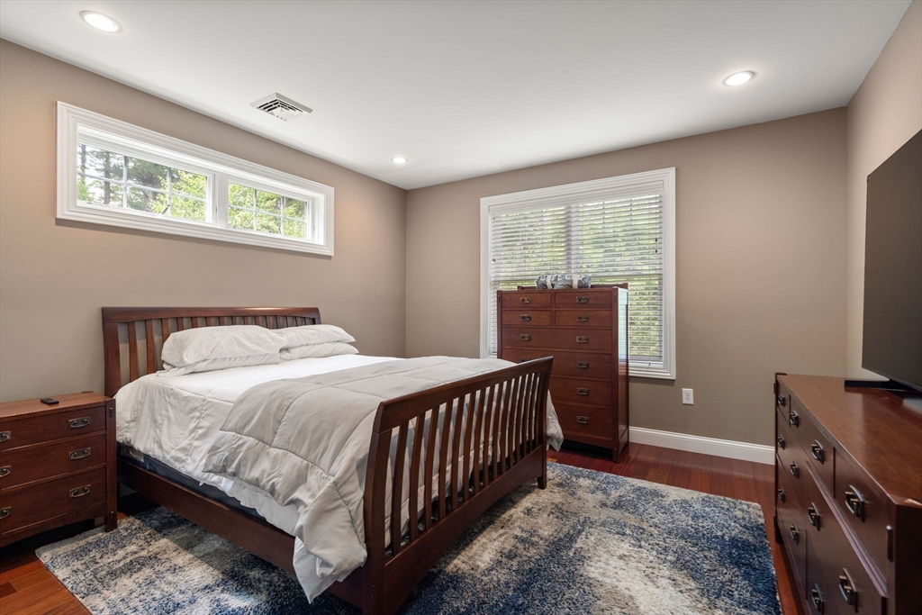 24 Wayside Inn Road Framingham, MA 01701 - Photo 26 of 38 a bedroom with a bed and a flat tv screen on the dresser