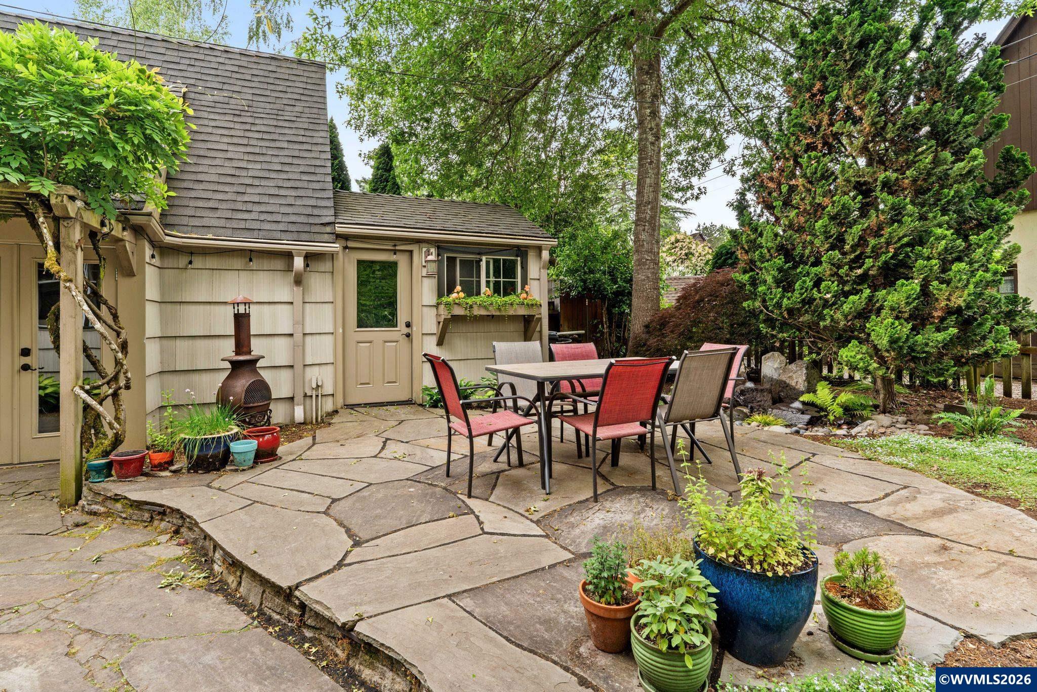 444 Northwest 35th Street Corvallis, OR 97330 - Photo 35 of 40 a view of a patio with table and chairs potted plants and a large tree