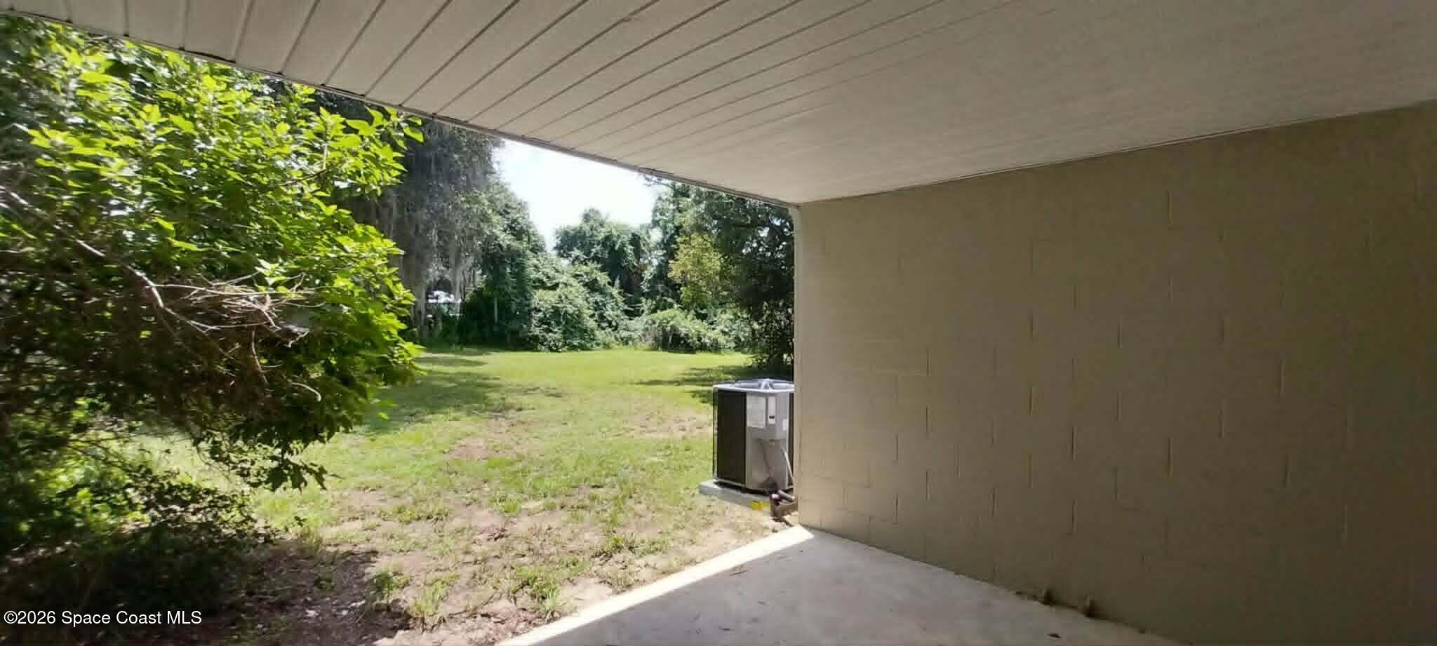 3509 Brevard Road Mims, FL 32754 - Photo 2 of 18 back yard from carport