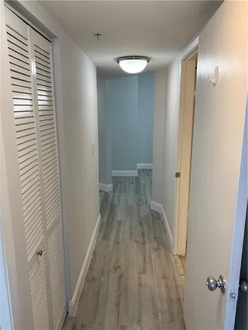 a view of a room with wooden floor and a sink
