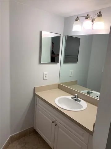 a bathroom with a sink and mirror