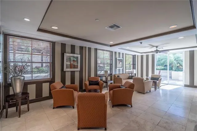 a living room with furniture and floor to ceiling windows