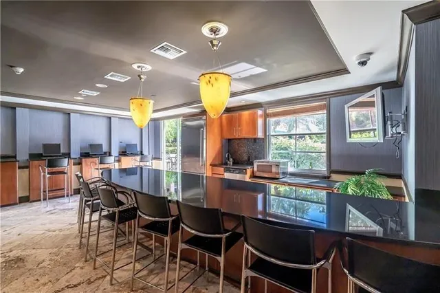 a dining room with furniture and a floor to ceiling window