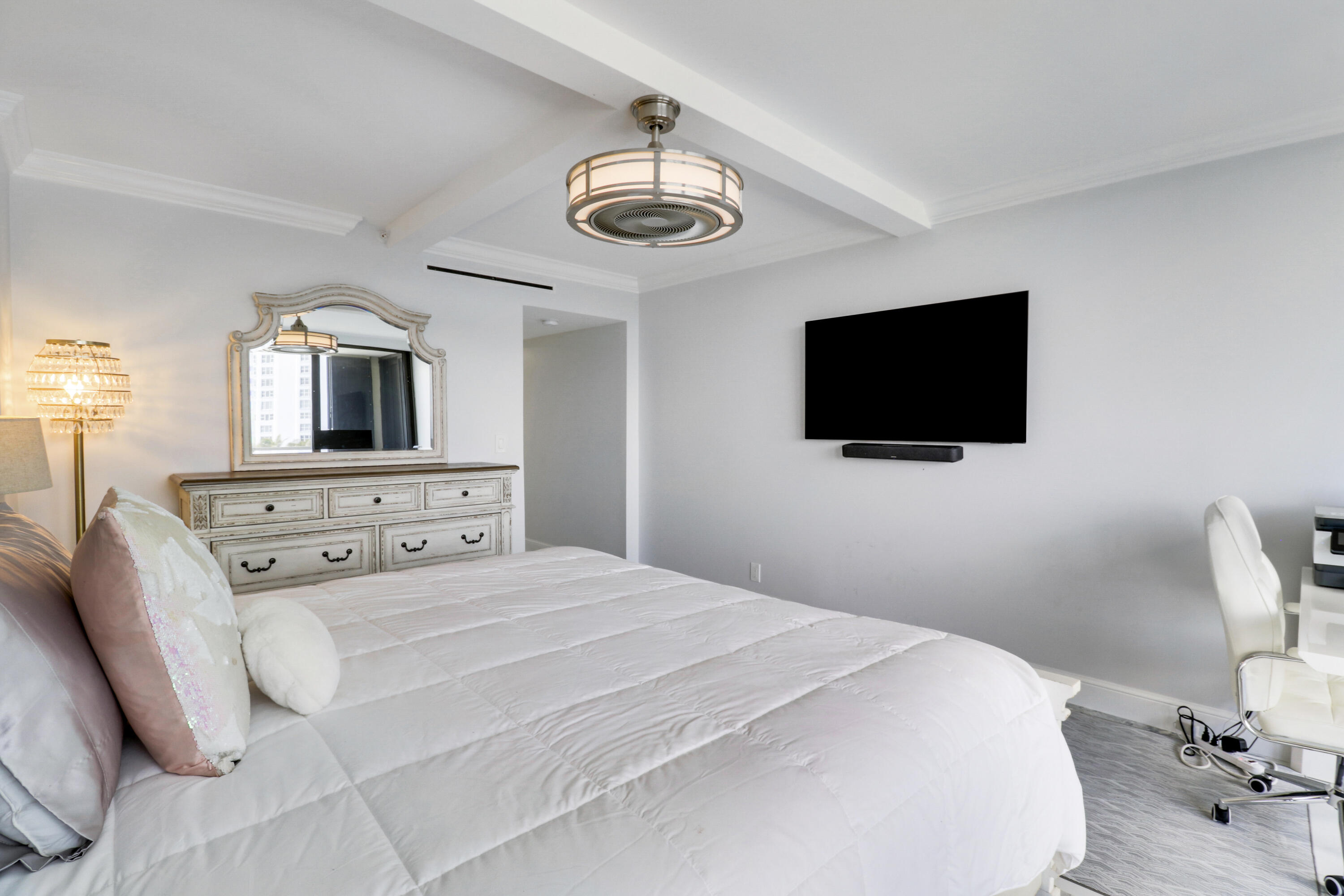 5280 North Ocean Drive, Unit 2F Riviera Beach, FL 33404 - Photo 18 of 35 a bedroom with a bed and a flat screen tv