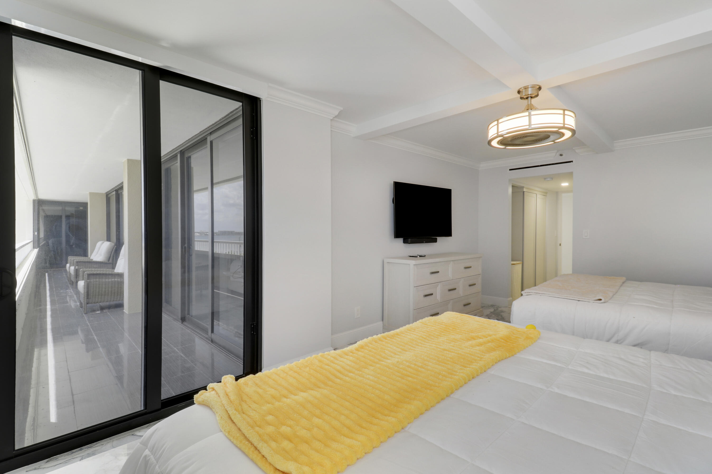 5280 North Ocean Drive, Unit 2F Riviera Beach, FL 33404 - Photo 20 of 35 a bedroom with a bed and a flat screen tv