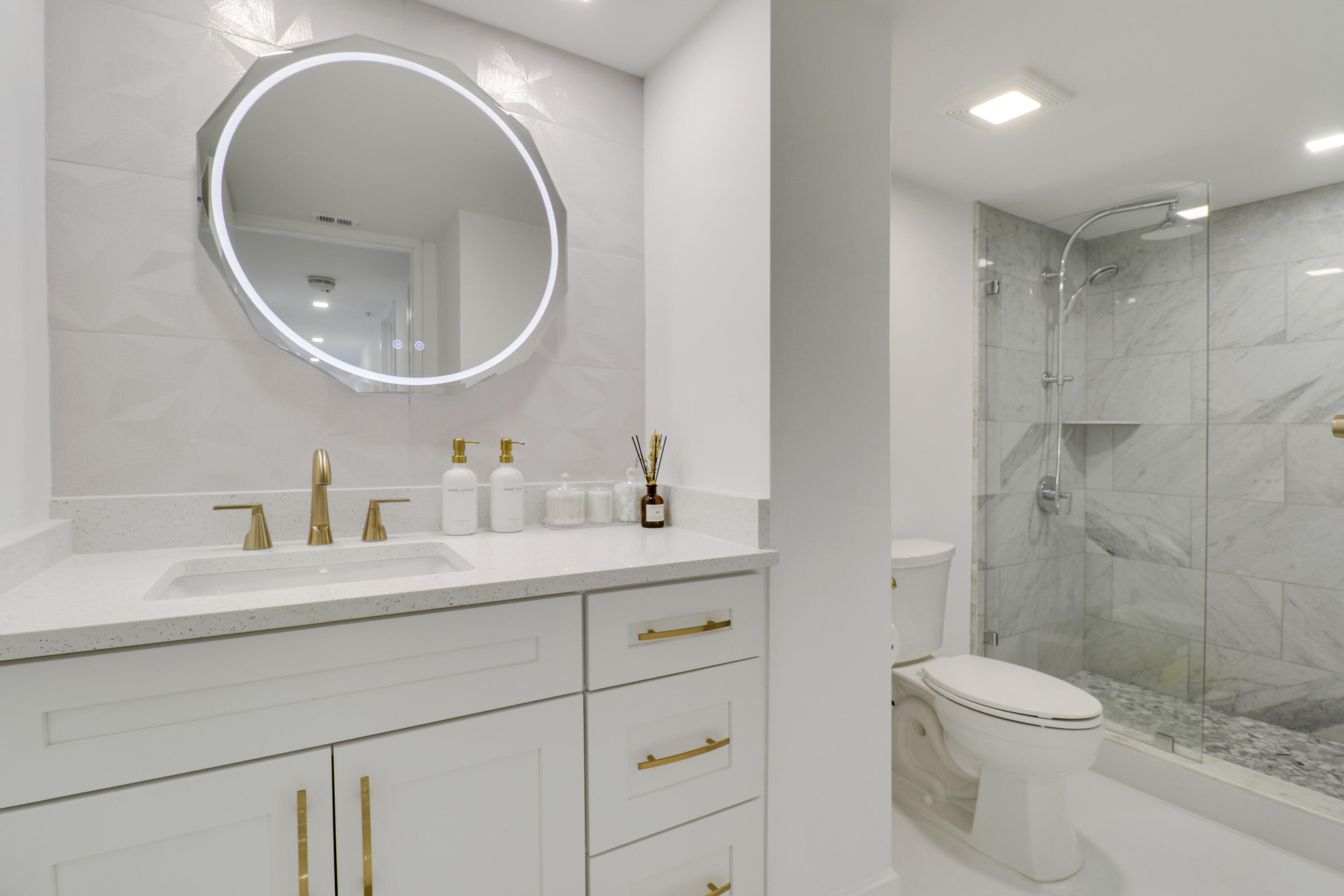 5280 North Ocean Drive, Unit 2F Riviera Beach, FL 33404 - Photo 21 of 35 a bathroom with a sink a toilet and a mirror