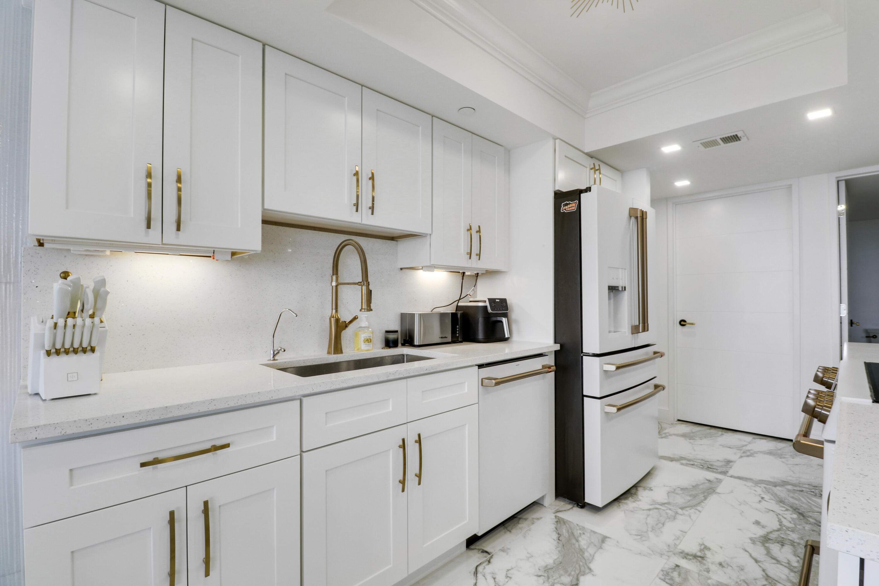 5280 North Ocean Drive, Unit 2F Riviera Beach, FL 33404 - Photo 4 of 35 a kitchen with appliances cabinets and a sink