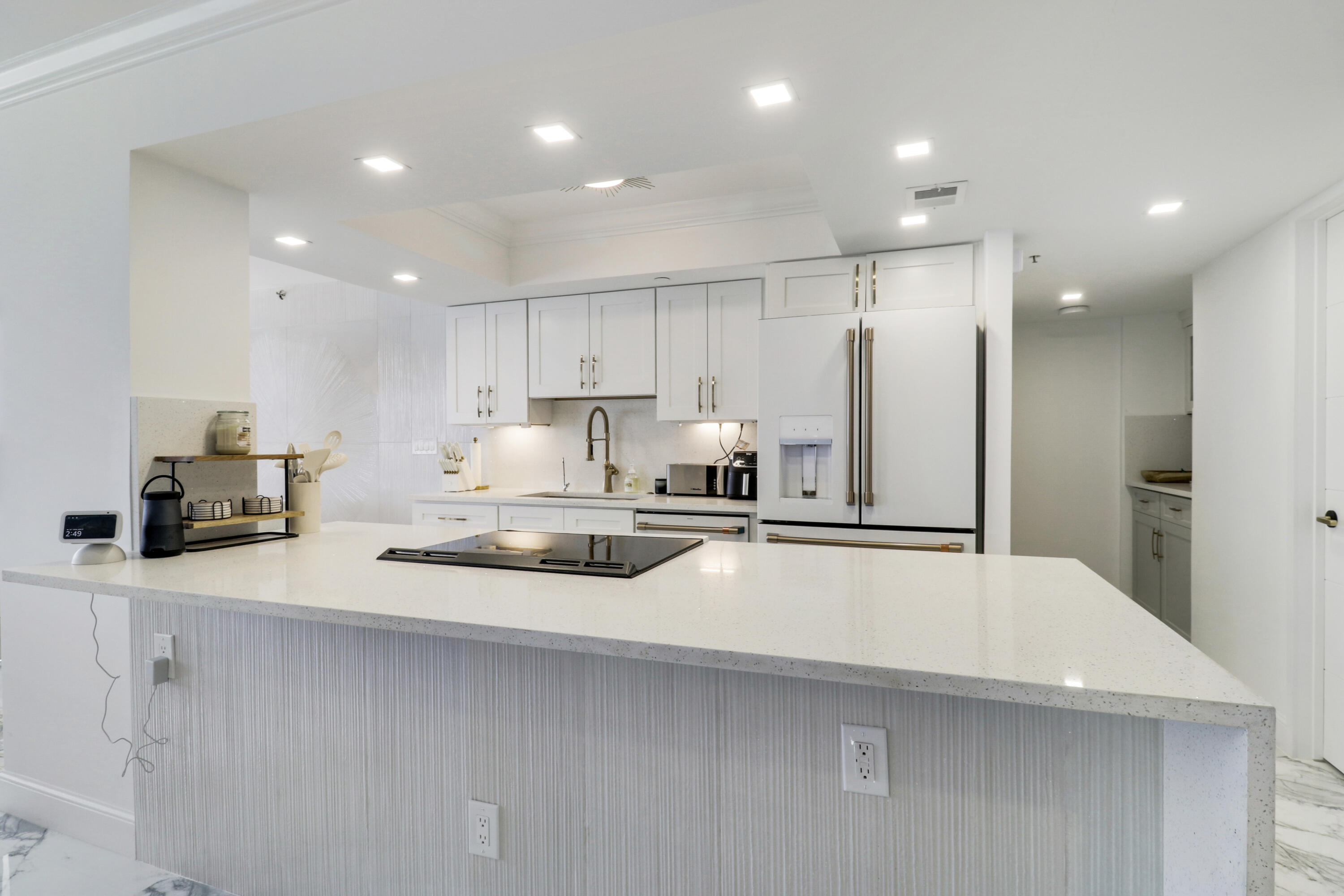 5280 North Ocean Drive, Unit 2F Riviera Beach, FL 33404 - Photo 5 of 35 a kitchen with stainless steel appliances a refrigerator sink and white cabinets