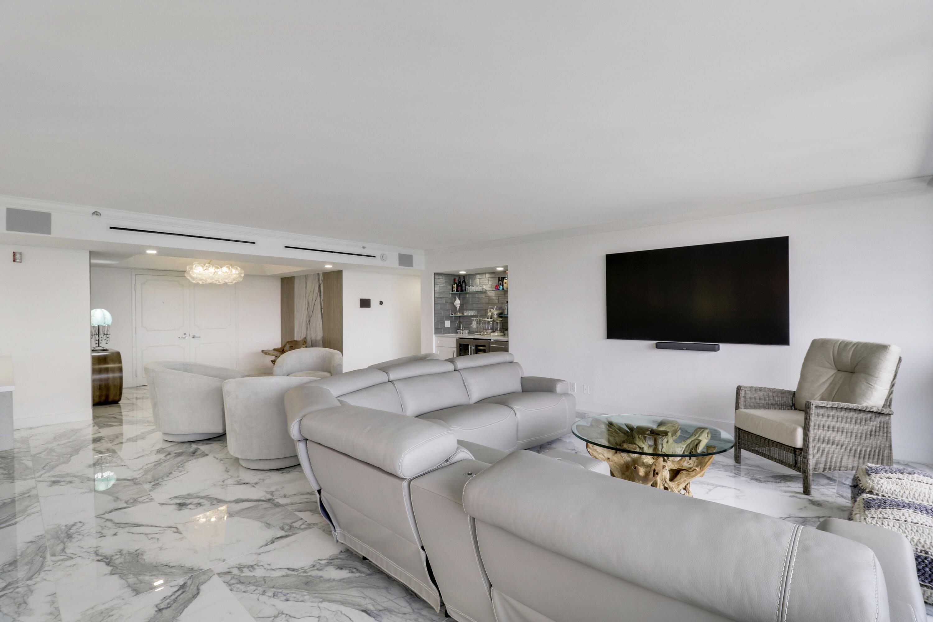 5280 North Ocean Drive, Unit 2F Riviera Beach, FL 33404 - Photo 7 of 35 a living room with furniture and a flat screen tv