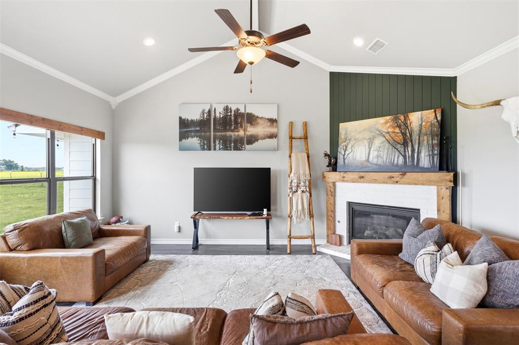 2990 Wilson Road Palmer, TX 75152 - Photo 10 of 40 a living room with furniture a fireplace and a flat screen tv