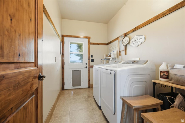 1634 West Arimo Road Arimo, ID 83214 - Photo 21 of 89 Laundry area featuring wood-finish trim, neutral wall tones, and tiled flooring