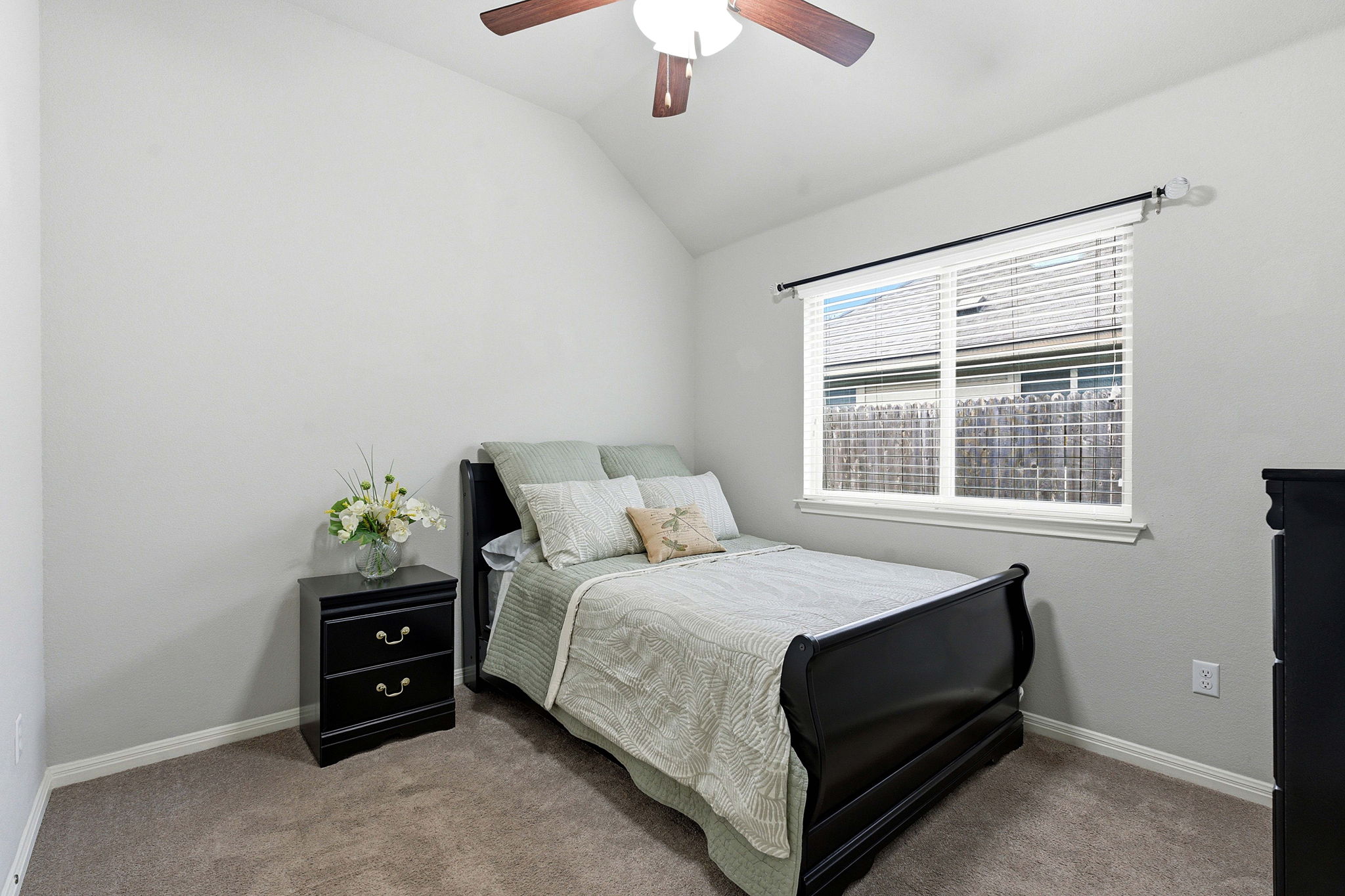426 Tilly Lane Buda, TX 78610 - Photo 13 of 21 Carpeted bedroom featuring lofted ceiling and a ceiling fan